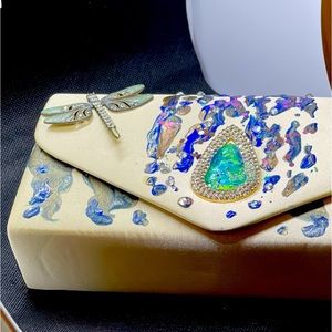 Hand painted clutch with a beautiful dragonfly pin to complete the look.